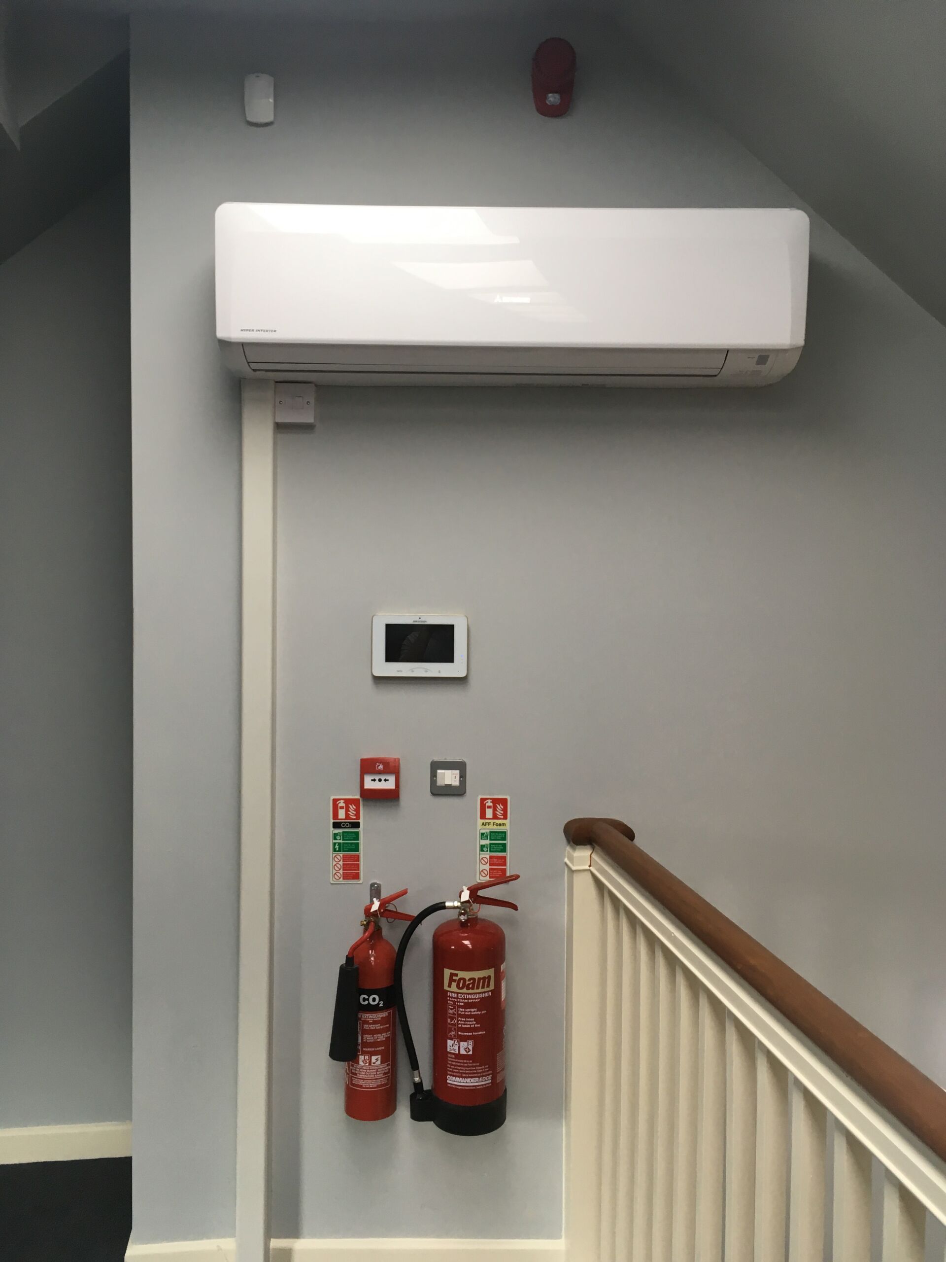 Air conditioning unit installed on a wall in a corridor